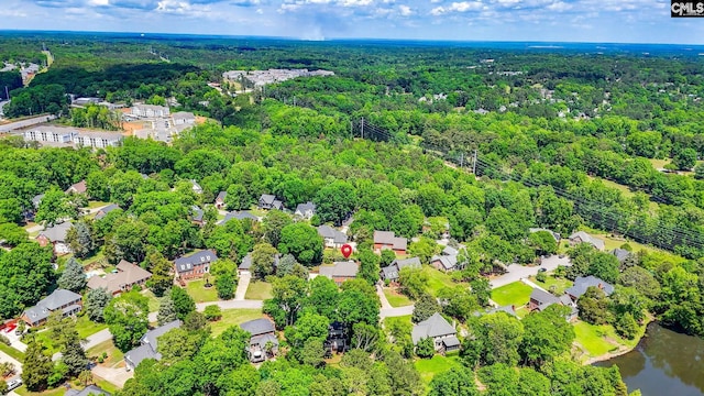 birds eye view of property featuring a wooded view