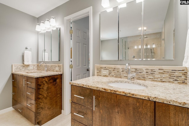 bathroom with decorative backsplash, a sink, and a stall shower