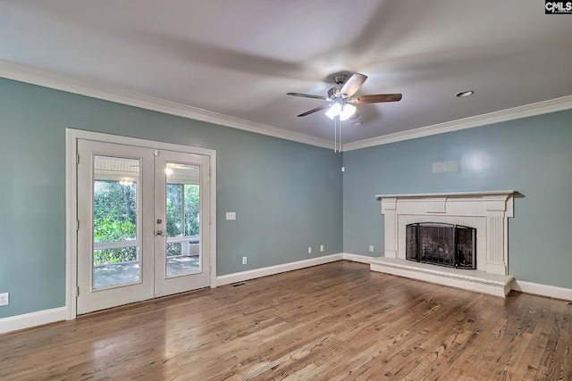 unfurnished living room featuring crown molding, a ceiling fan, baseboards, and french doors