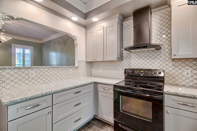 kitchen with ornamental molding, decorative backsplash, wall chimney range hood, and black range with electric stovetop