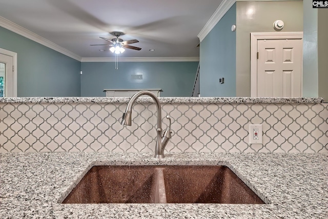 room details with ceiling fan, light stone counters, a sink, and tasteful backsplash