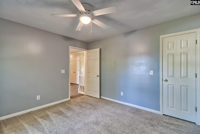 unfurnished bedroom with baseboards, a ceiling fan, and carpet