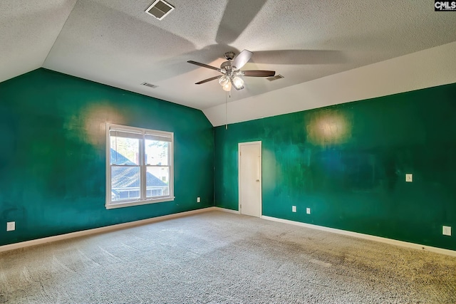 unfurnished room featuring visible vents, carpet flooring, ceiling fan, and lofted ceiling