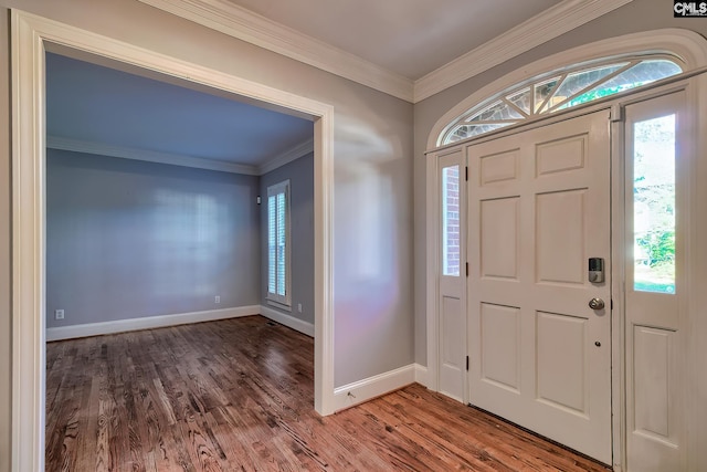 foyer entrance featuring crown molding, baseboards, and wood finished floors
