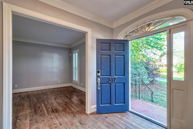 foyer entrance with baseboards, ornamental molding, and wood finished floors