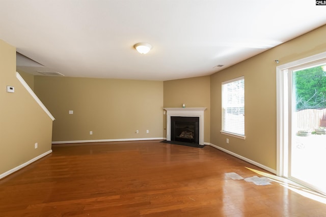 236 Crimson Oak Dr, Lexington, SC 29072 - unfurnished living room featuring baseboards, a fireplace with flush hearth, wood finished floors, and visible vents