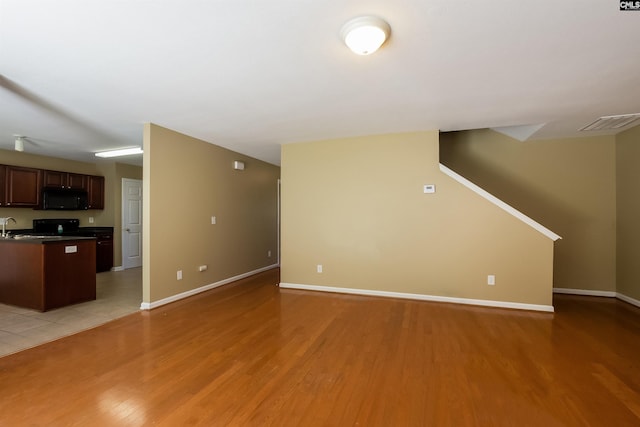 236 Crimson Oak Dr, Lexington, SC 29072 - unfurnished living room featuring baseboards, a sink, light wood finished floors, and visible vents