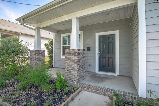 property entrance with covered porch