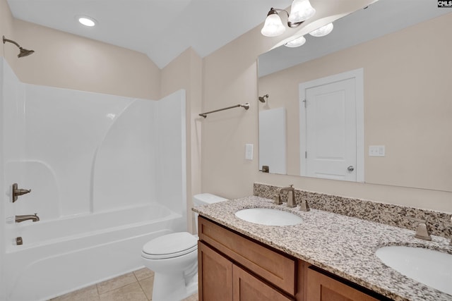 full bathroom featuring a sink, washtub / shower combination, tile patterned floors, and toilet