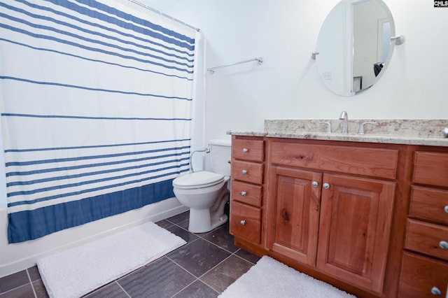 bathroom featuring vanity, tile patterned floors, and toilet