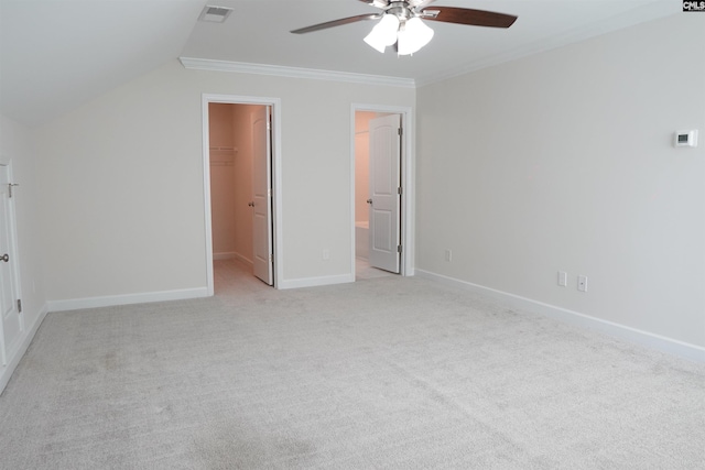 509 Malachite Ln, Chapin, SC 29036 - unfurnished bedroom featuring visible vents, ornamental molding, a walk in closet, light colored carpet, and vaulted ceiling