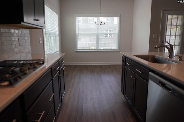 509 Malachite Ln, Chapin, SC 29036 - kitchen with decorative backsplash, a sink, an inviting chandelier, stainless steel appliances, and dark wood-type flooring