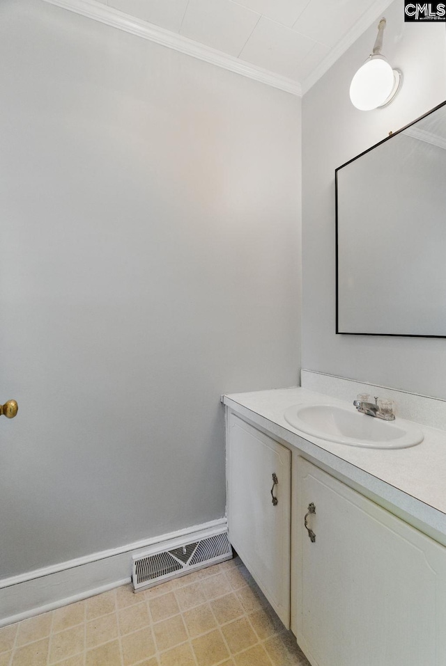 bathroom with baseboards, visible vents, ornamental molding, and vanity