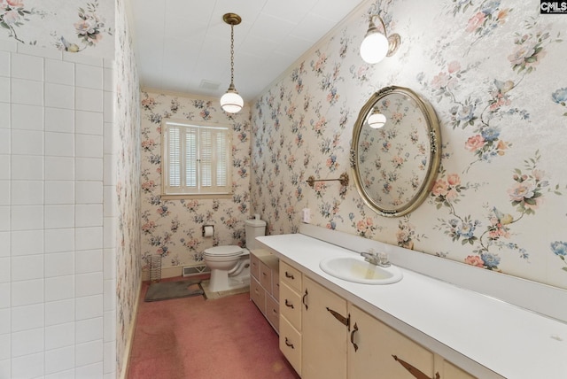 full bathroom with visible vents, vanity, toilet, ornamental molding, and wallpapered walls