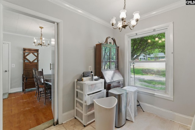 dining room with ornamental molding, a chandelier, and a healthy amount of sunlight