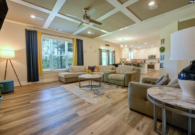 309 Creek Ridge Loop, Blythewood, SC 29016 - living area with baseboards, light wood-type flooring, ceiling fan with notable chandelier, and coffered ceiling