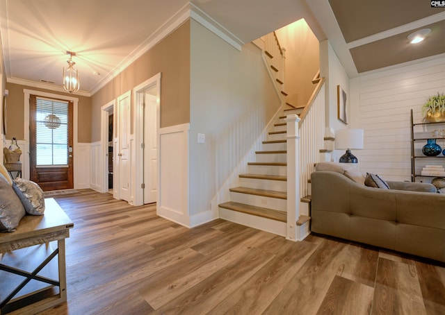 309 Creek Ridge Loop, Blythewood, SC 29016 - interior space featuring crown molding, a decorative wall, a chandelier, wood finished floors, and stairway