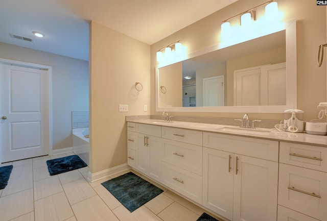 309 Creek Ridge Loop, Blythewood, SC 29016 - bathroom featuring double vanity, visible vents, a sink, and a bath