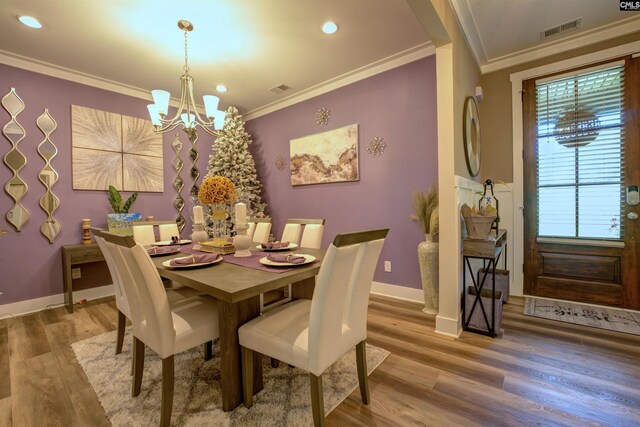 309 Creek Ridge Loop, Blythewood, SC 29016 - dining room with crown molding, visible vents, an inviting chandelier, and wood finished floors