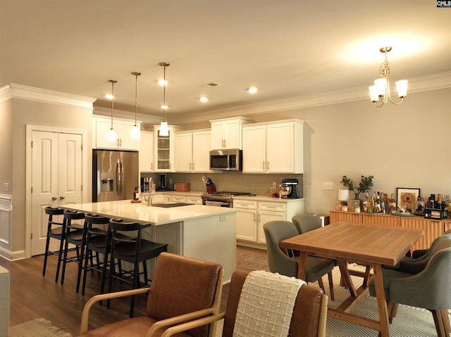 433 Outer Banks Dr, Lexington, SC 29072 - kitchen with appliances with stainless steel finishes, crown molding, decorative backsplash, a kitchen breakfast bar, and a center island with sink
