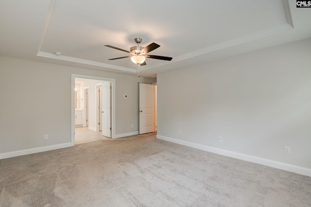 433 Outer Banks Dr, Lexington, SC 29072 - spare room with ornamental molding, ceiling fan, light carpet, a tray ceiling, and baseboards