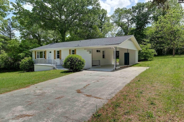 single story home with a carport, a front yard, and concrete driveway