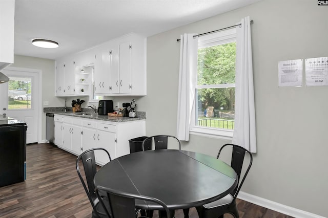 dining area featuring baseboards and dark wood finished floors