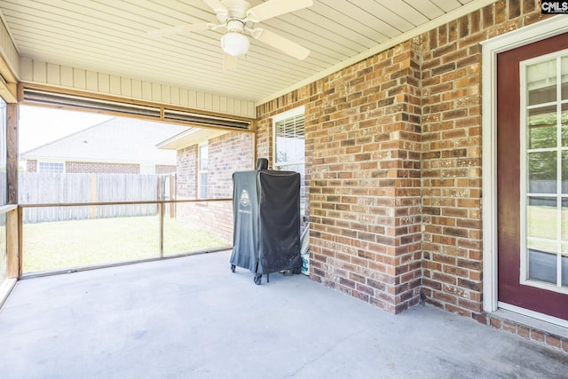 unfurnished sunroom featuring plenty of natural light and ceiling fan