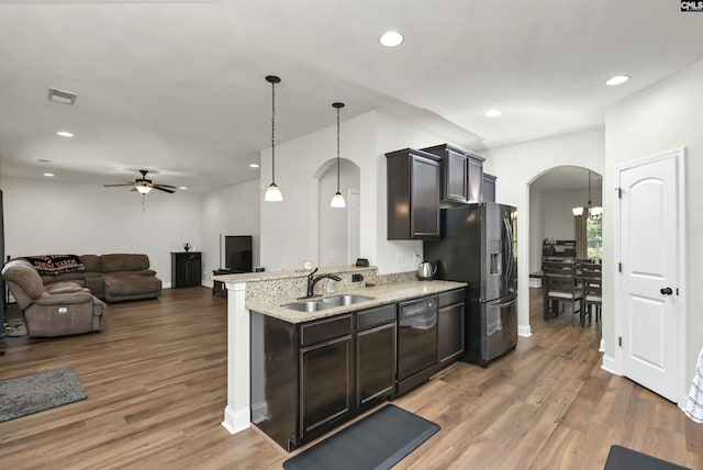 kitchen featuring ceiling fan, visible vents, arched walkways, dishwasher, and a sink