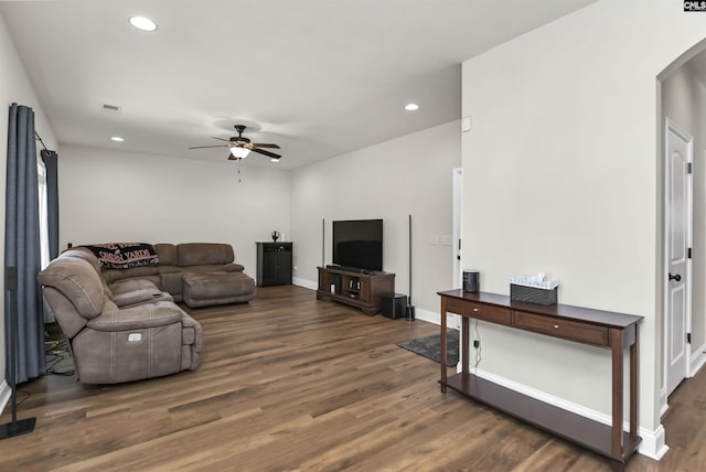 living room with a ceiling fan, arched walkways, wood finished floors, baseboards, and recessed lighting