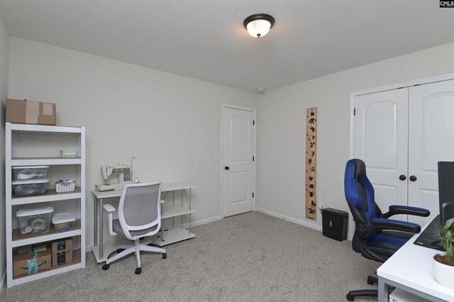 carpeted office space with baseboards