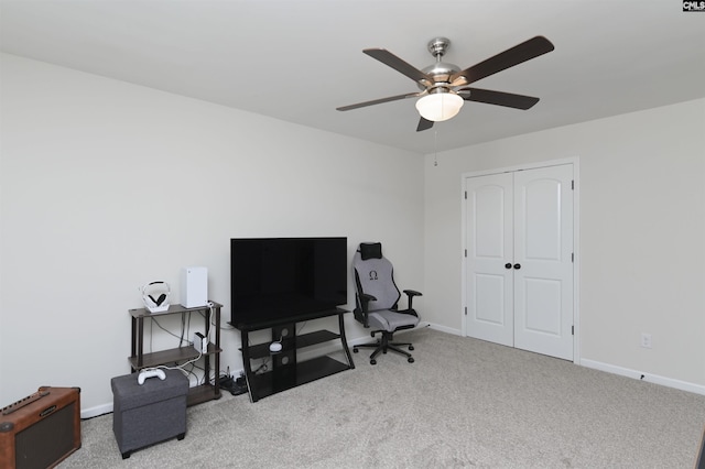 carpeted office with a ceiling fan and baseboards