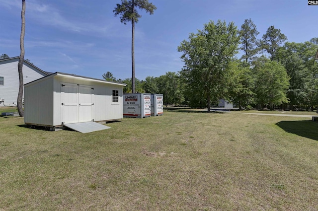 view of yard featuring a shed and an outbuilding