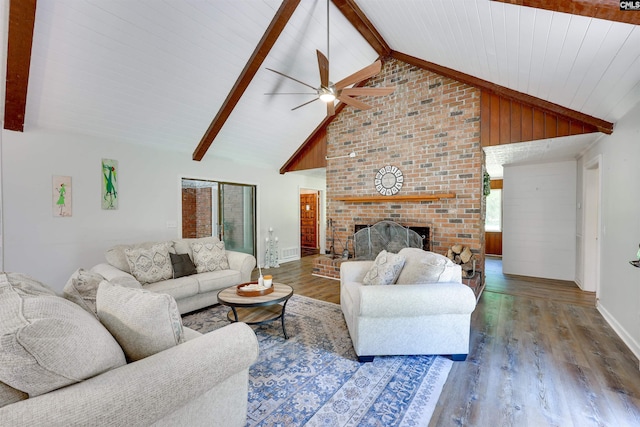 living area with baseboards, a ceiling fan, wood finished floors, and beam ceiling