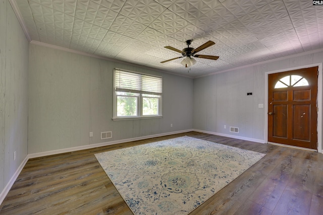 interior space with visible vents, ornamental molding, and hardwood / wood-style flooring