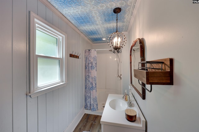 bathroom with vanity, baseboards, wood finished floors, and a shower with shower curtain