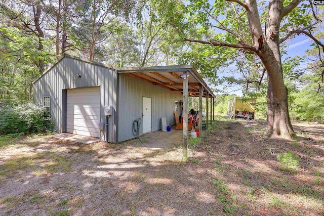exterior space with an outdoor structure and dirt driveway