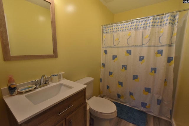 bathroom featuring vanity, wood finished floors, toilet, and a shower with curtain