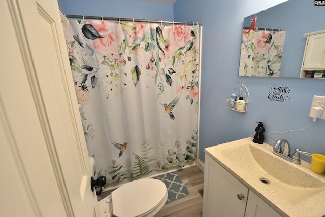 full bath featuring vanity, wood finished floors, toilet, and a shower with curtain