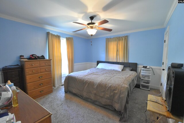 bedroom featuring crown molding, carpet floors, and a ceiling fan
