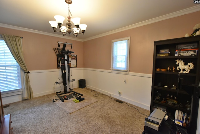 exercise area featuring crown molding, carpet, a notable chandelier, and a healthy amount of sunlight