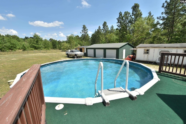 outdoor pool featuring an outdoor structure, fence, and a yard