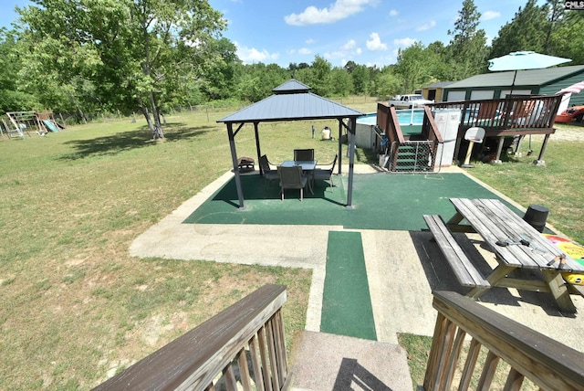 view of yard featuring a gazebo, a playground, and a patio area