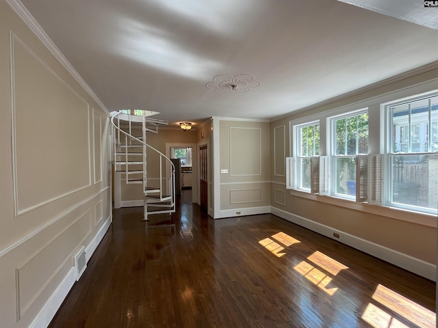 interior space with stairs, dark wood-style flooring, and ornamental molding