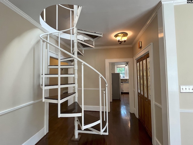 stairway with crown molding, baseboards, and wood finished floors