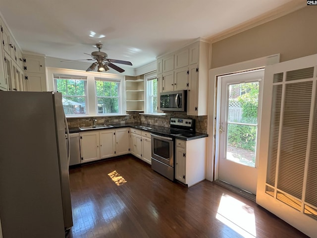 kitchen with a sink, dark countertops, plenty of natural light, and stainless steel appliances