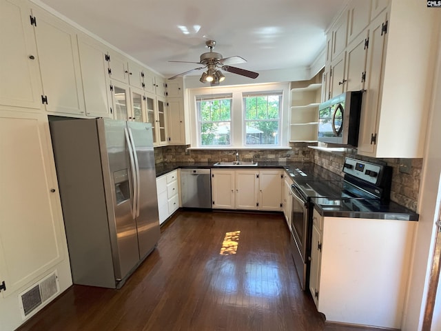 kitchen featuring dark countertops, appliances with stainless steel finishes, a sink, and visible vents