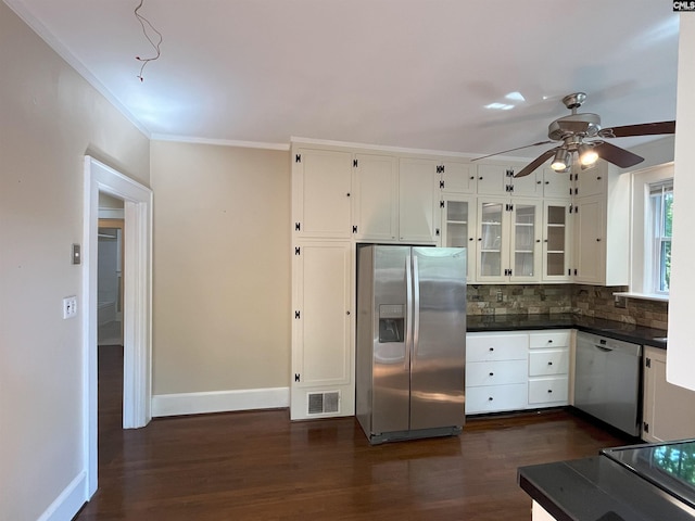 kitchen featuring dark countertops, ceiling fan, stainless steel fridge, visible vents, and dishwashing machine