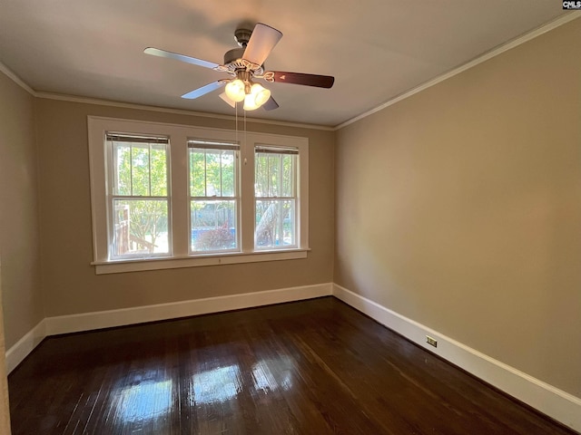 spare room with baseboards, crown molding, dark wood-type flooring, and a ceiling fan