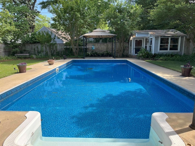 view of swimming pool with an outdoor structure, a storage structure, a fenced backyard, a fenced in pool, and a gazebo